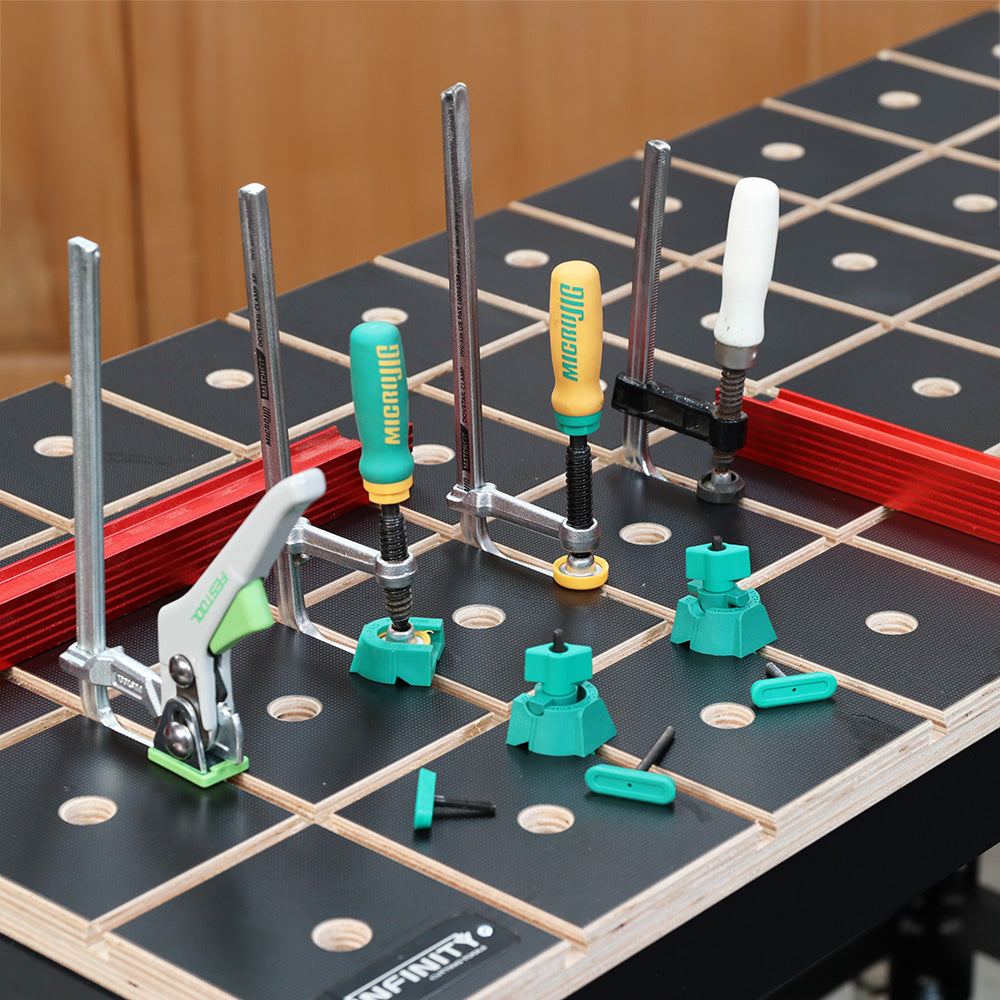 Woodworking bench with grid pattern, hold-down clamps, and green workbench accessories