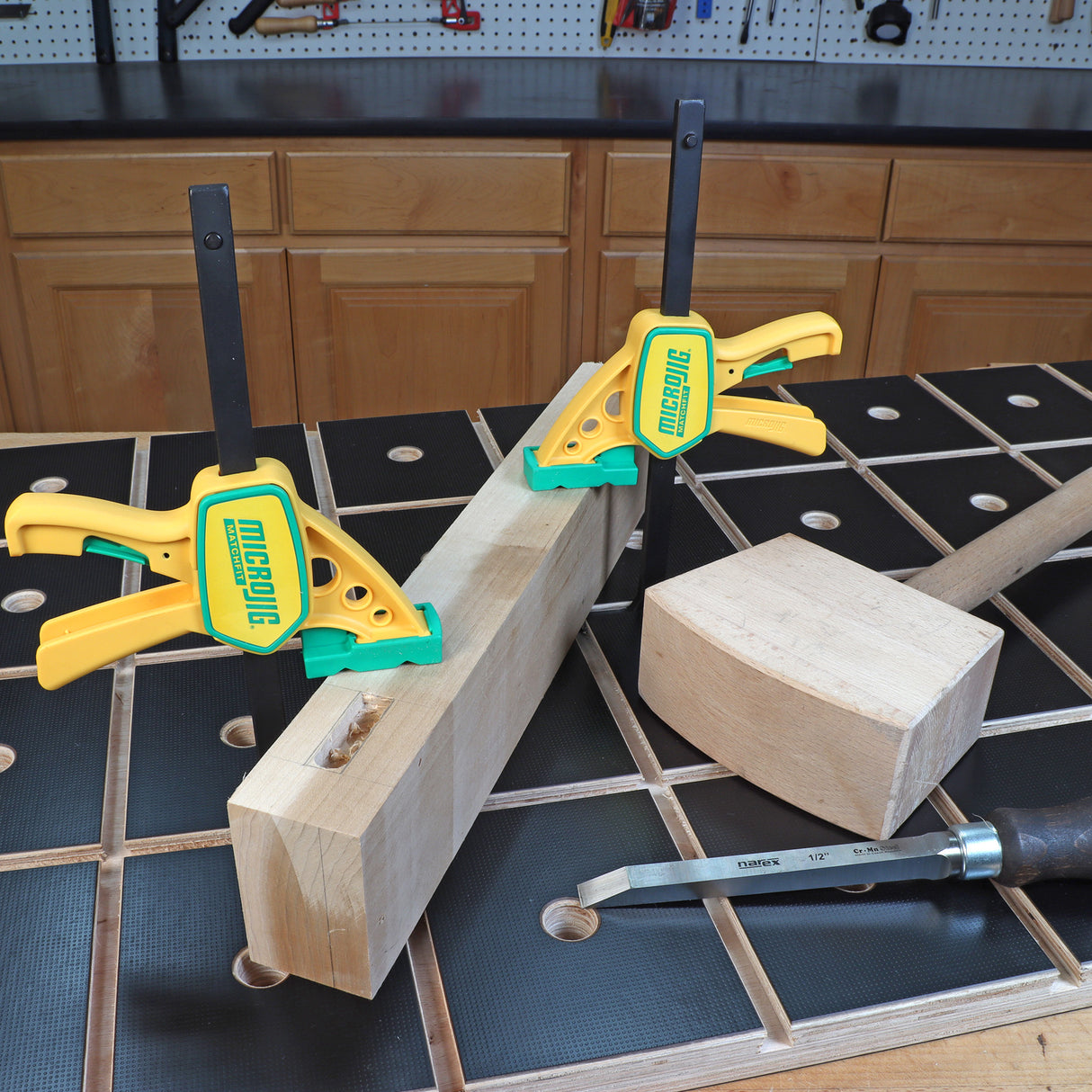 Woodworking bench with clamped board, mallet, and chisel for precision joinery