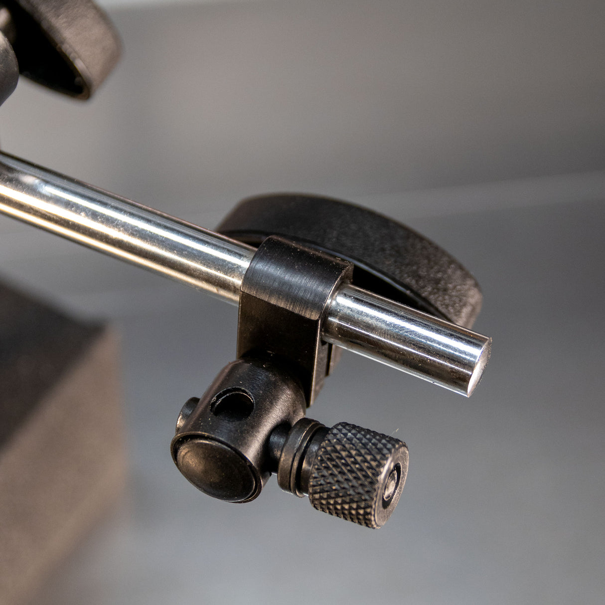 Closeup of a magnetic base metal clamp with adjustment knob for woodworking tools