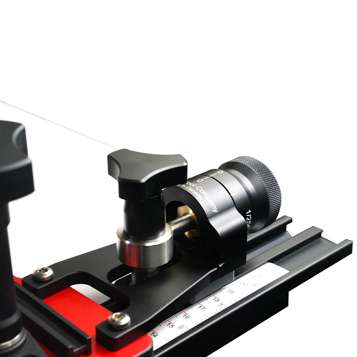 Close-up of woodworking micro-adjuster tool with precision scale on metal rail