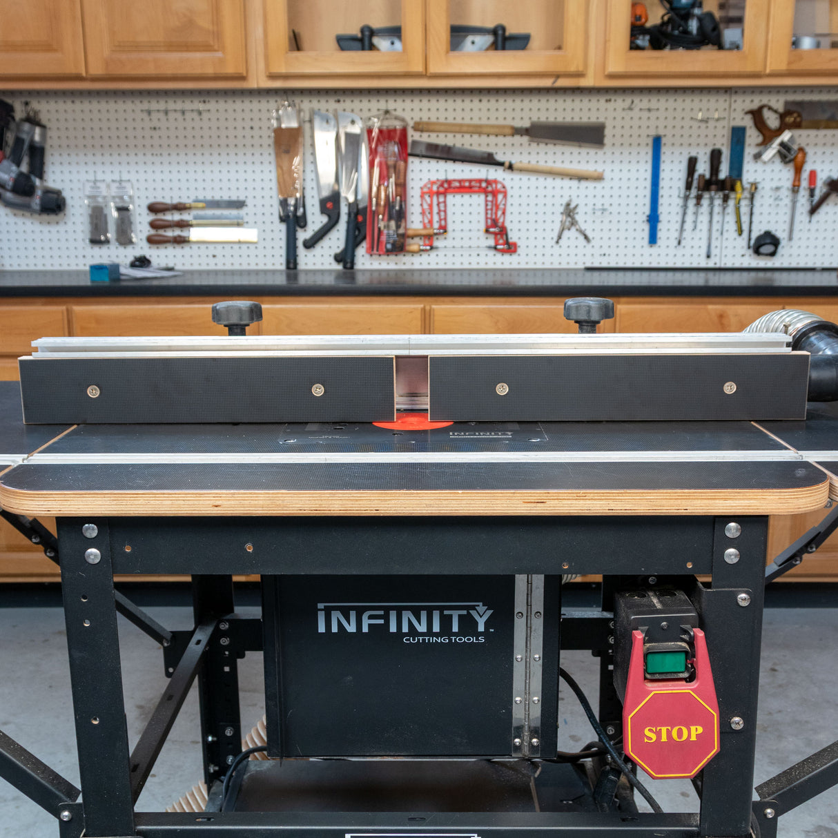 Router table with MDF fence and dust collection in woodworking shop setting