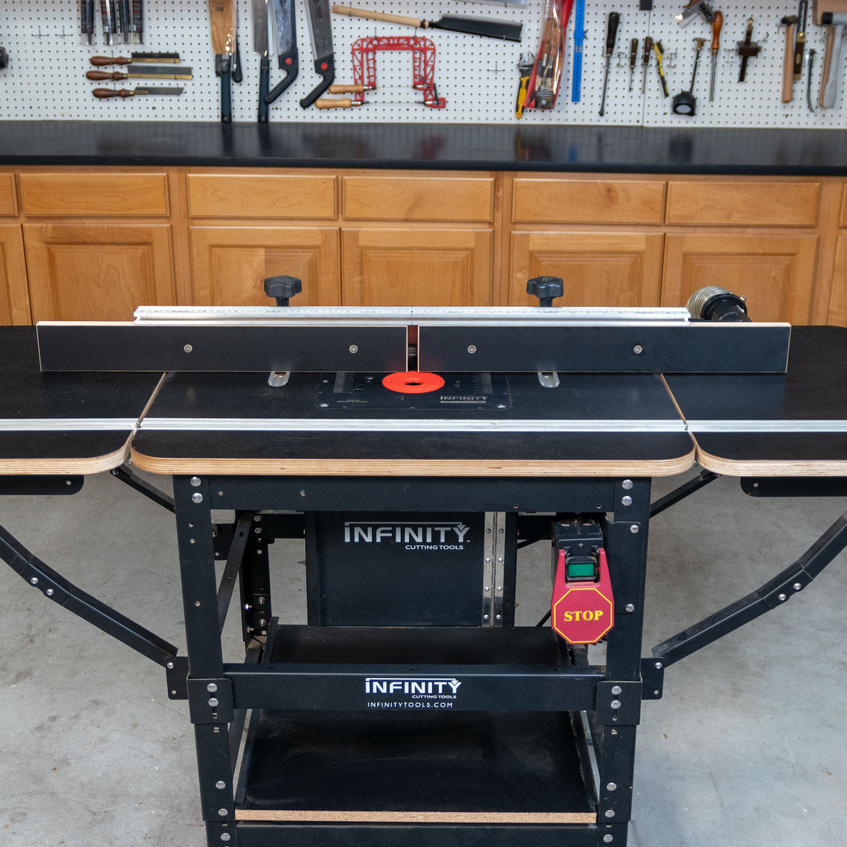Router table with extension fence faces set in woodworking shop setting