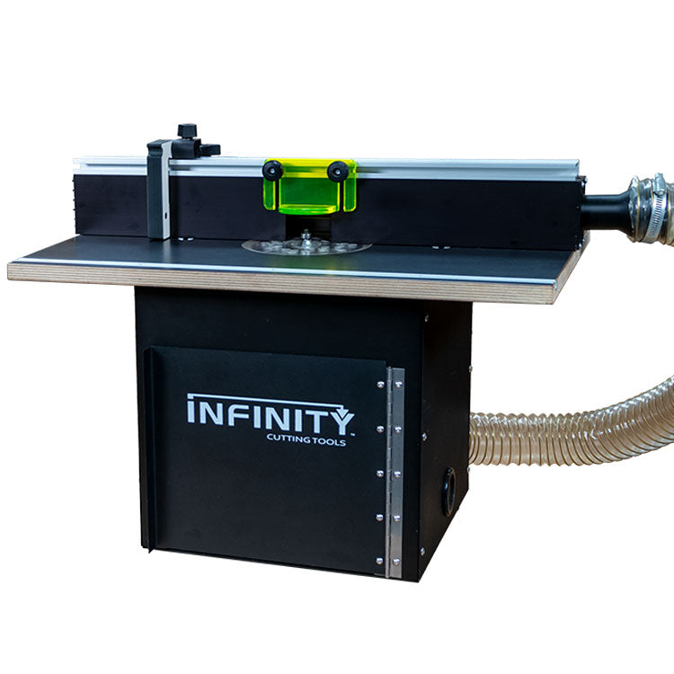 Router table with fence, dust collection hose, and clear safety guard for woodworking.