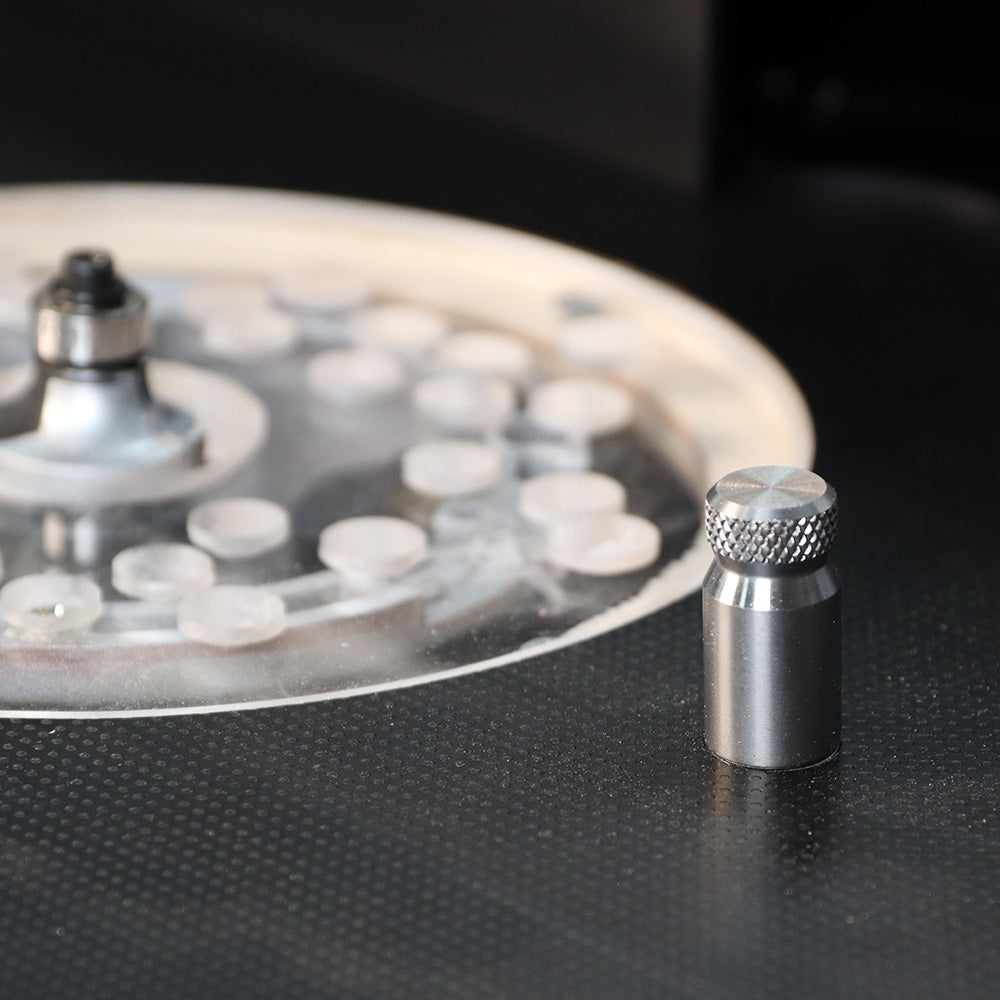 Router table setup with metal alignment pin and clear insert plate for woodworking precision