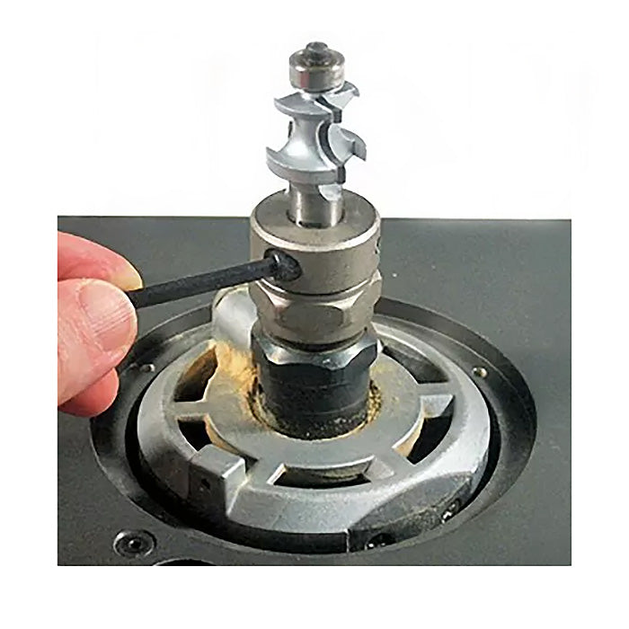 Hand adjusting router lift with hex key on a woodworking router table