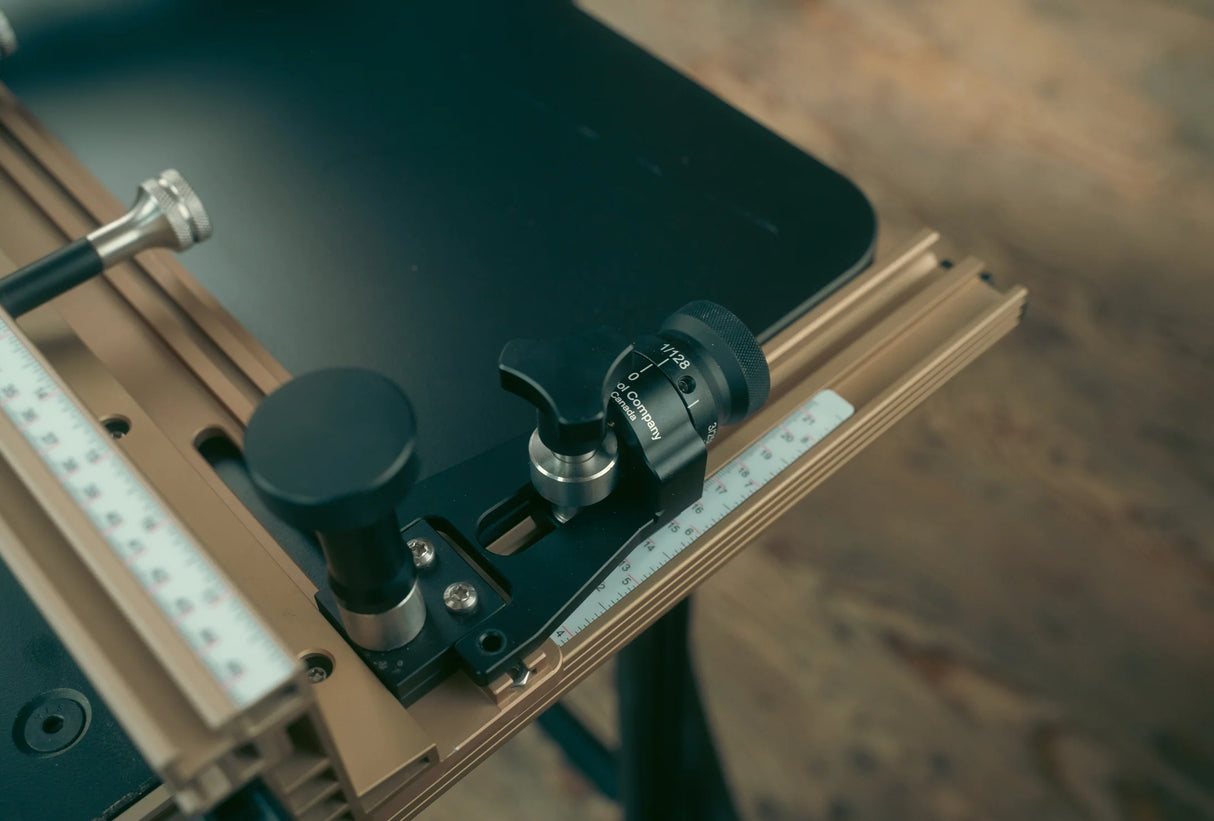 Router table fence with precision adjustment knobs and integrated measuring scale for woodworking.