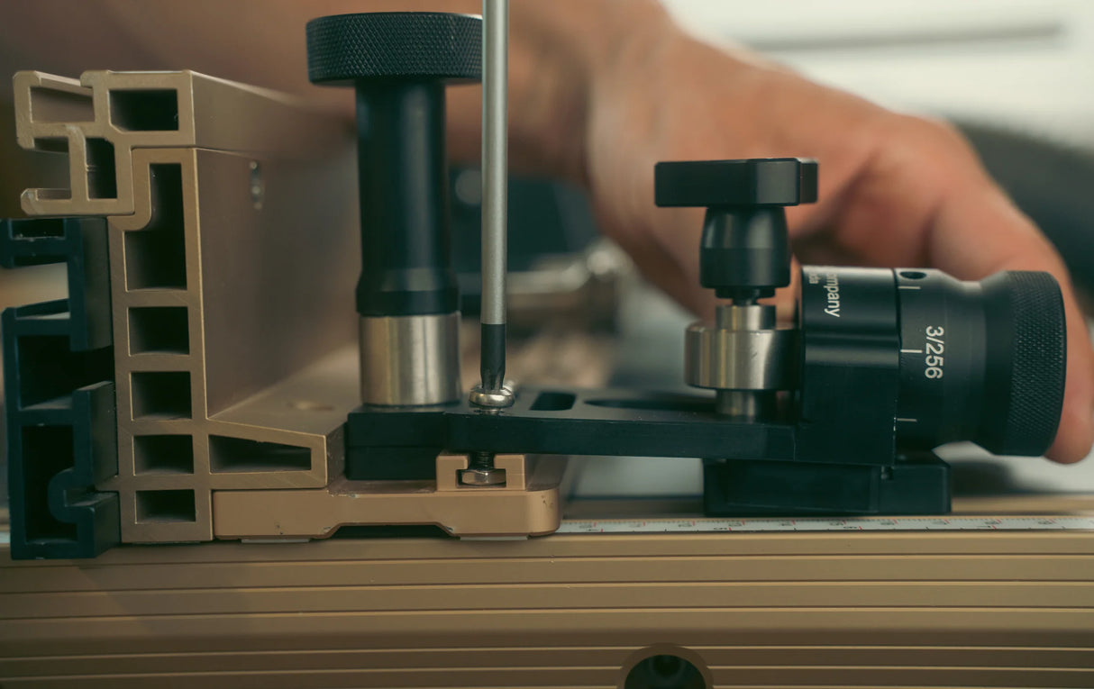 Close-up of a woodworking jig and ruler with hand adjusting precision tool