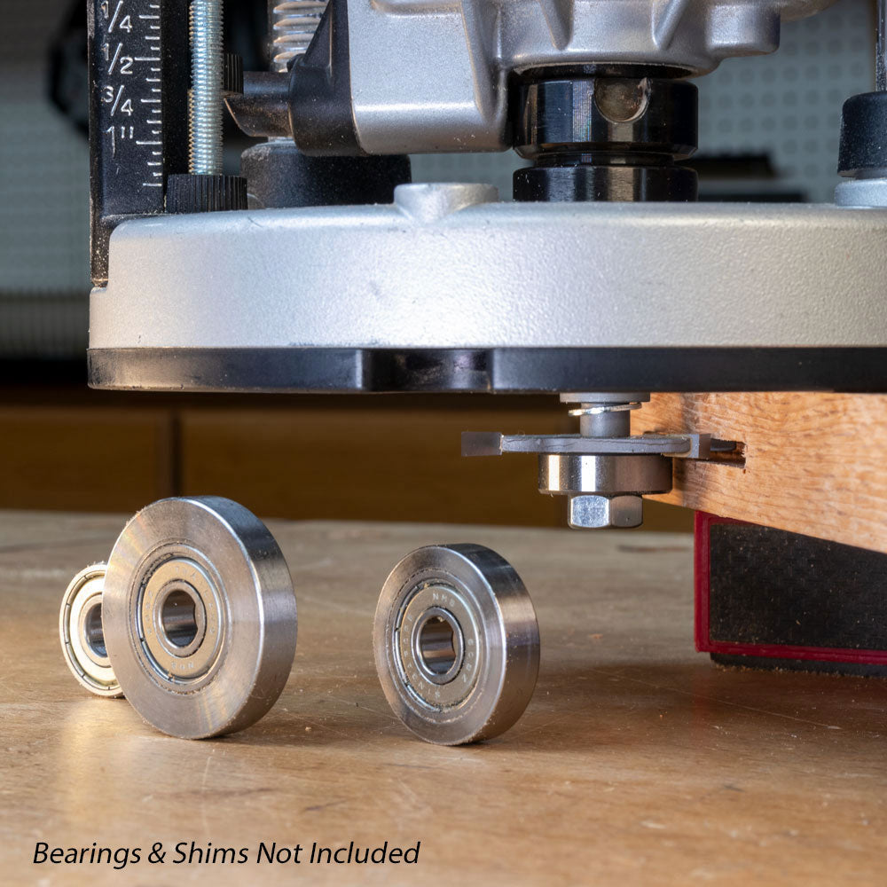 Slot cutter arbor installed on router with bearings and shims on workbench