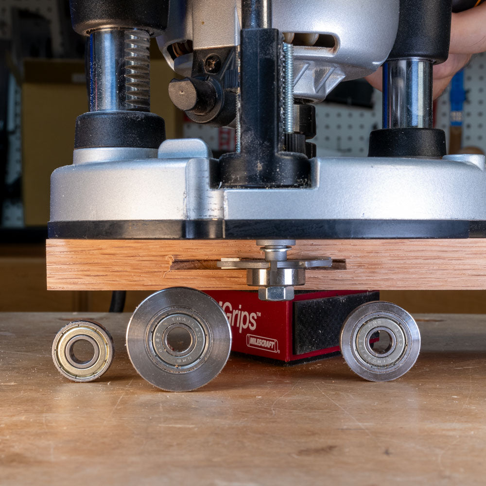 Slot cutter arbor with router and bearings on a wooden workbench for woodworking tools