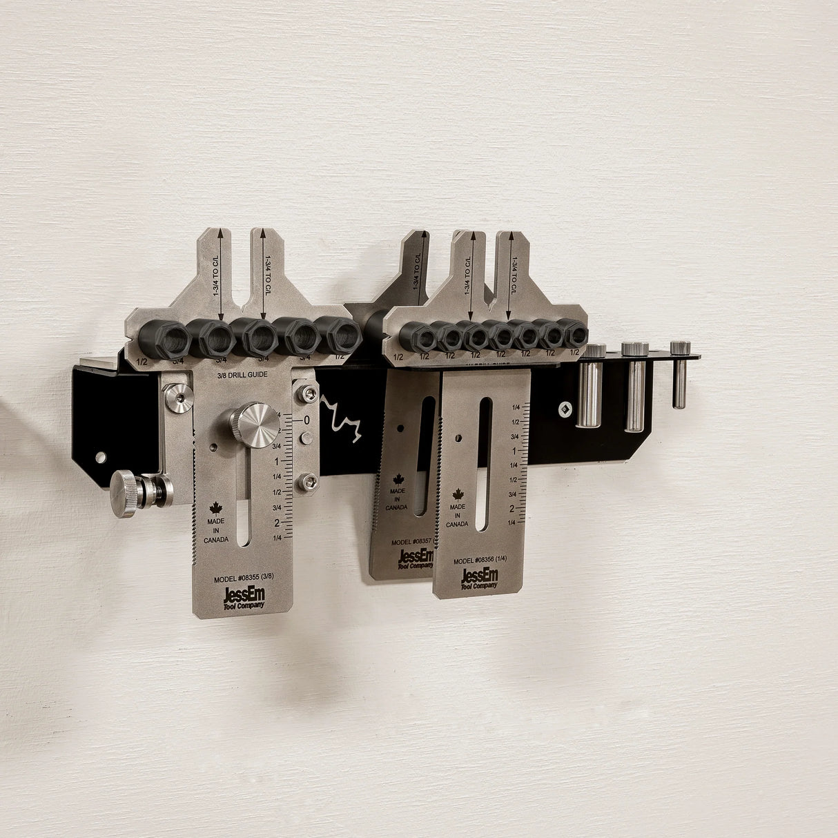 Wall-mounted woodworking dowel jig system with metal components and measurement guides.