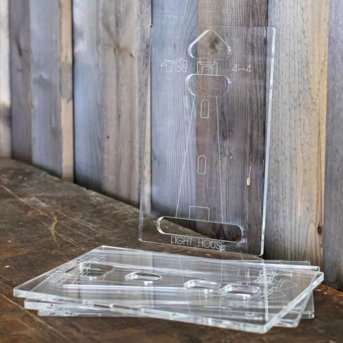 Acrylic router templates with lighthouse design for woodworking on a rustic wooden table