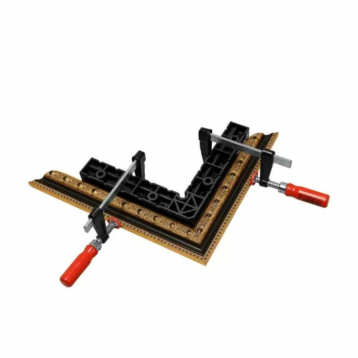 Corner clamp securing ornate wood picture frame for precise woodworking joinery