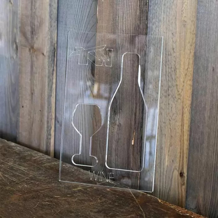 Acrylic wine bottle and glass woodworking template on rustic wood background