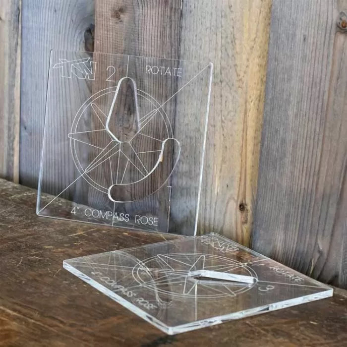 Clear acrylic compass rose router templates on wooden surface, woodworking tool guides.