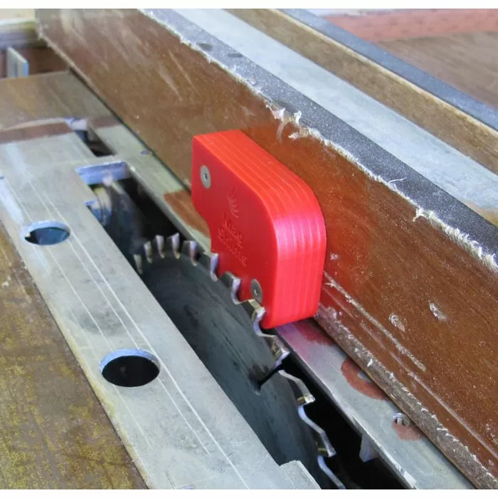 Table saw blade height gauge positioned on circular saw blade for woodworking setup