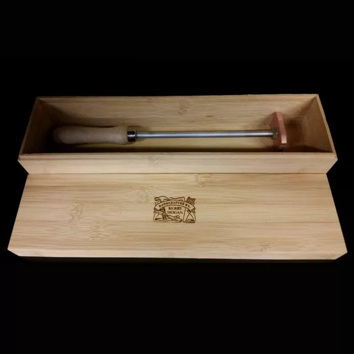 Woodworking branding iron with wooden handle in engraved wooden gift box on black background
