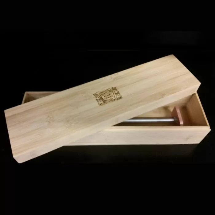 Wooden storage box with sliding lid, containing a metal woodworking tool, on black background