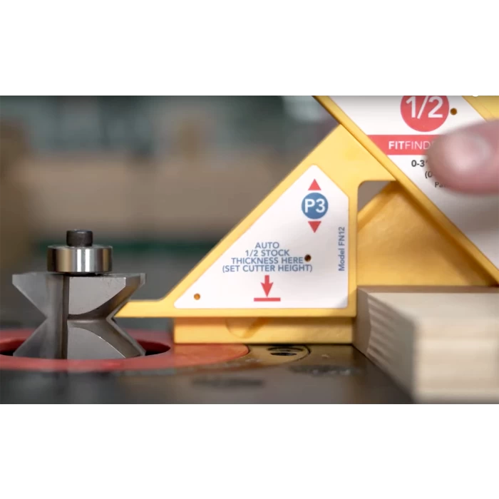 Router table setup with router bit, yellow gauge, and wood stock for precise cutting