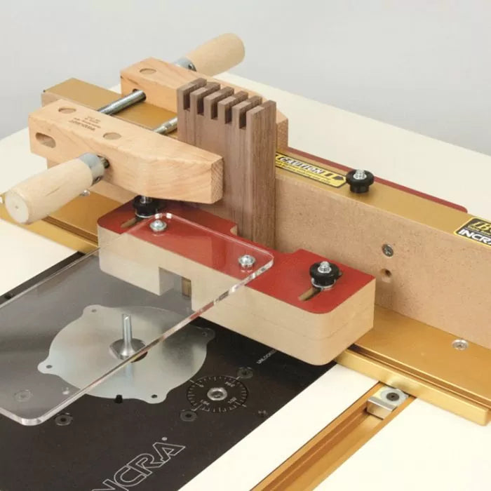 Router table dovetail jig with wooden workpiece and precision fence for woodworking