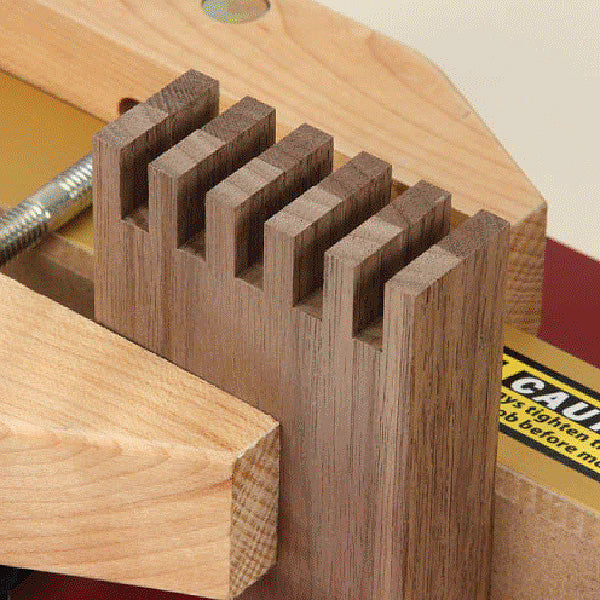 Close-up of dovetail joint woodworking with jig and router table