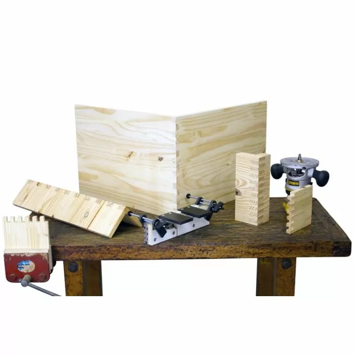 Woodworking dovetail jig, router, and dovetail joint boards on workbench