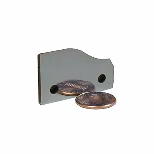 Carbide planer knife with sharp edge and two holes, shown next to two coins on white background