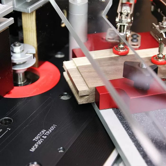 Woodworking router table jig in use, clamping wood for precise cutting and joinery.