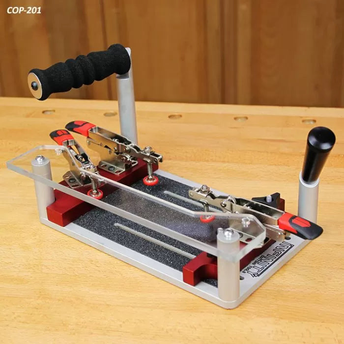 Woodworking coping sled with handles and clamps on a workbench, used for precise router cuts