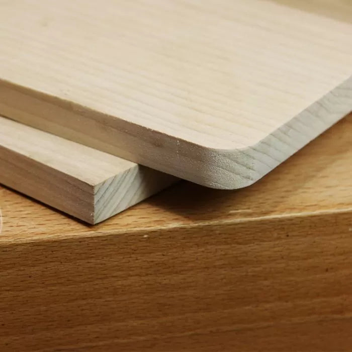 Close-up of smooth wooden boards with rounded and square edges, ideal for woodworking projects