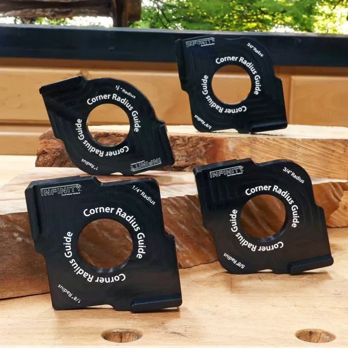 Set of four black corner radius guide woodworking tools on stacked wooden boards