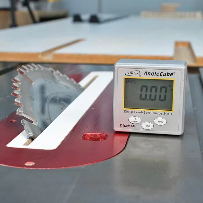 Digital angle gauge measuring table saw blade bevel on woodworking table