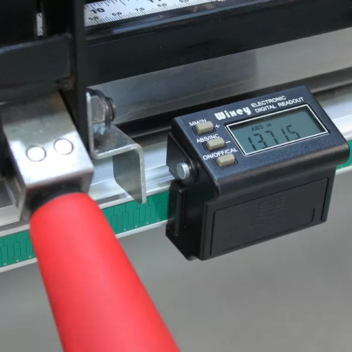Close-up of electronic digital readout gauge mounted on metal woodworking fence