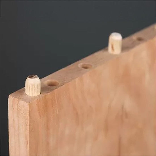 Wooden board edge with dowel joinery and drilled holes for woodworking projects