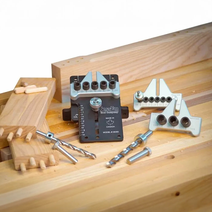 Woodworking dowel jig kit with drill bits and wooden boards on a workbench