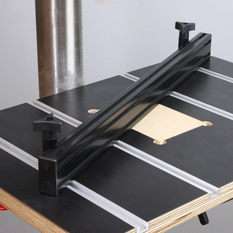 Drill press fence mounted on woodworking drill press table with T-tracks and adjustment knobs