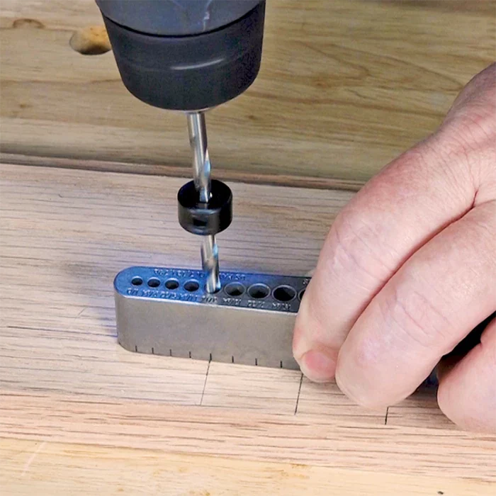 Drill collar stop attached to drill bit for precise hole depth in woodworking jig