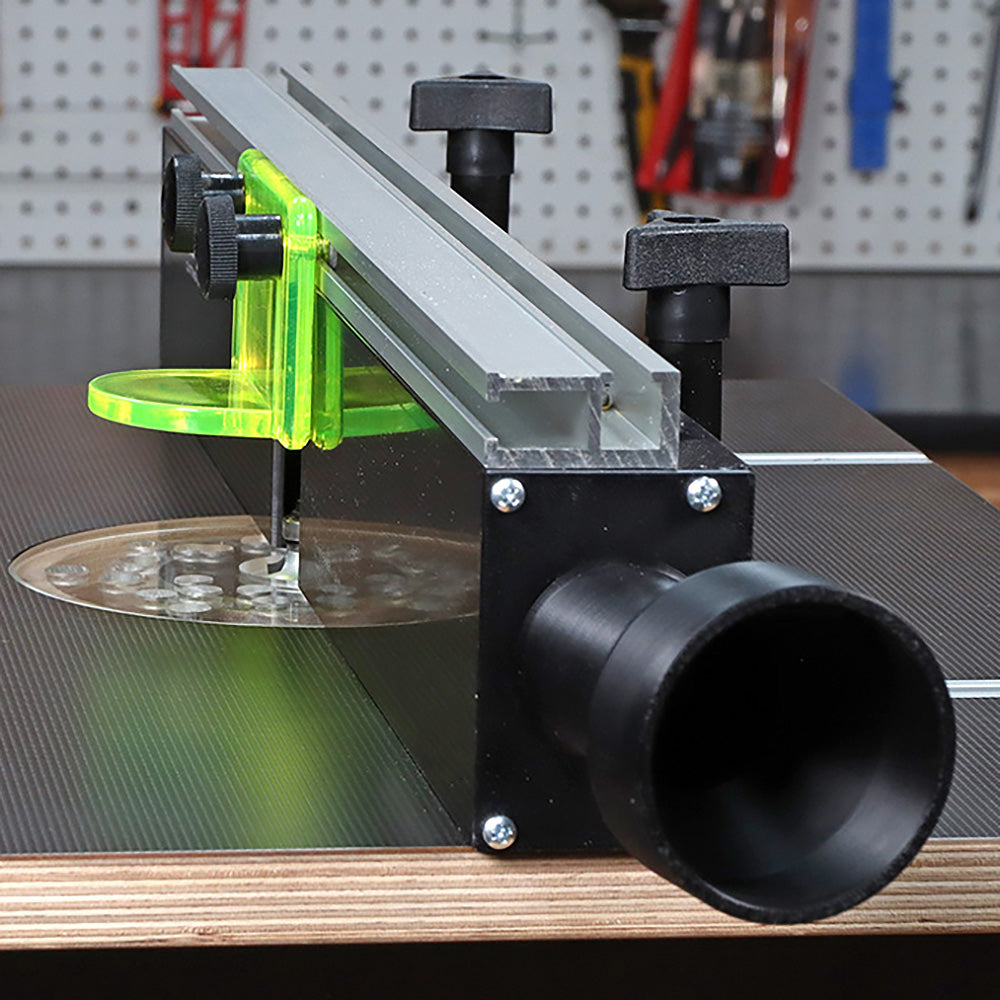 Router table fence with dust collection port and safety guard in woodworking shop