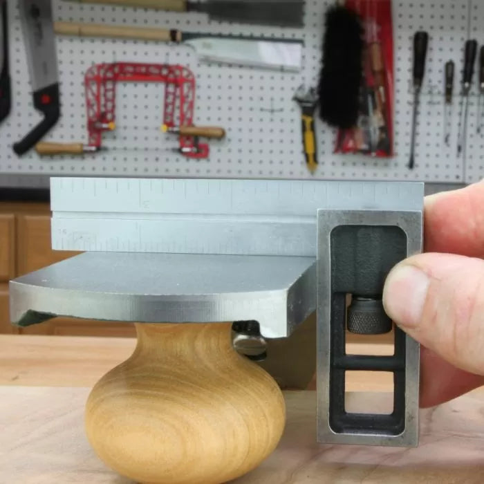 Checking hand plane sole flatness with precision square and ruler in woodworking shop