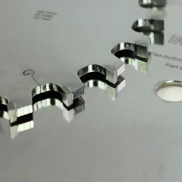 Close-up of carbide-tipped saw blade teeth for woodworking precision cutting.