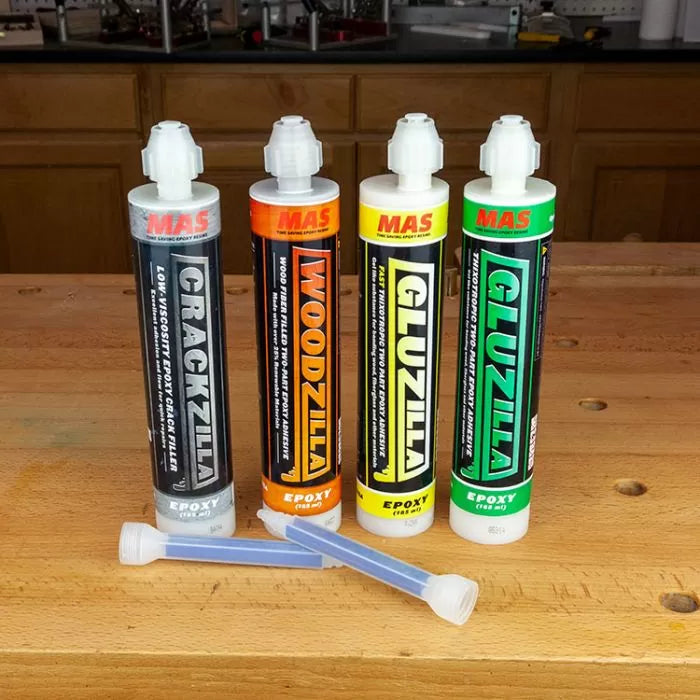 Epoxy adhesive cartridges labeled Crackzilla, Woodzilla, and Gluzilla on a woodworking bench