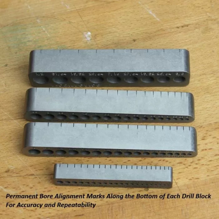 Metal drill blocks with bore alignment marks on wooden surface, woodworking tools.