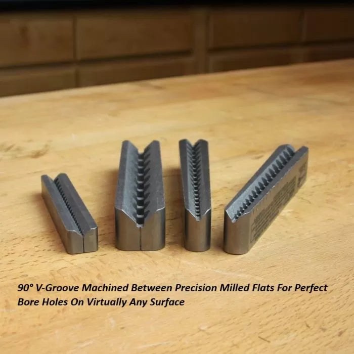 Set of precision milled V-groove woodworking jigs on a workbench for accurate bore holes