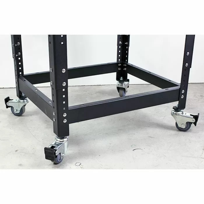 Heavy-duty metal workbench base frame with four locking caster wheels on concrete floor