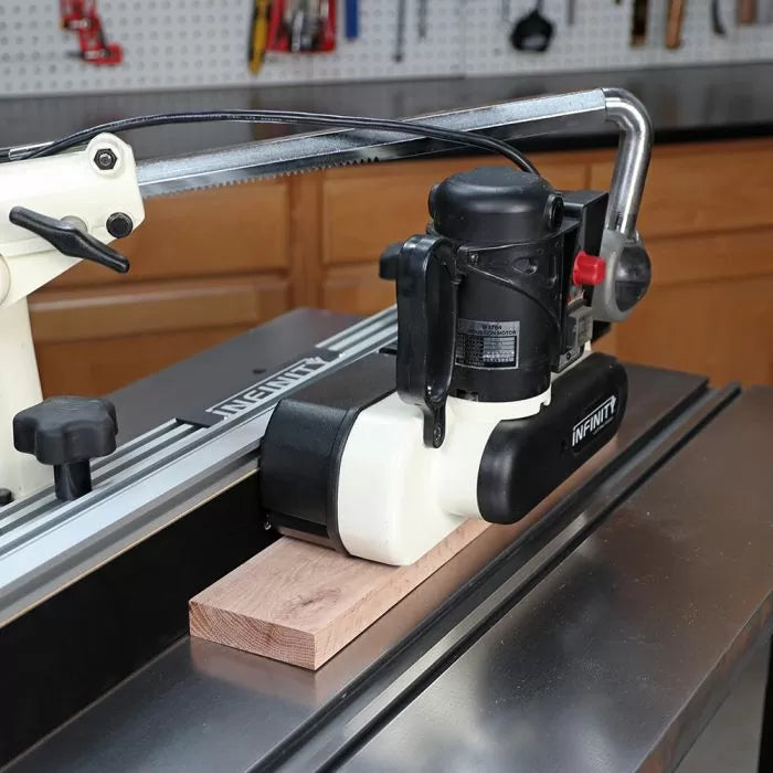 Woodworking power tool cutting a wood board on a metal workstation in a workshop