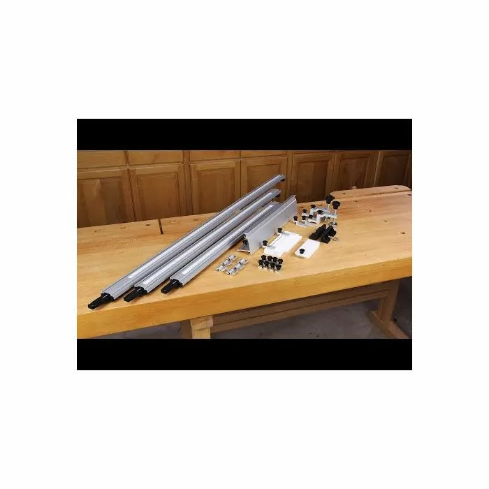 Woodworking router table fence kit with aluminum rails and hardware on workbench
