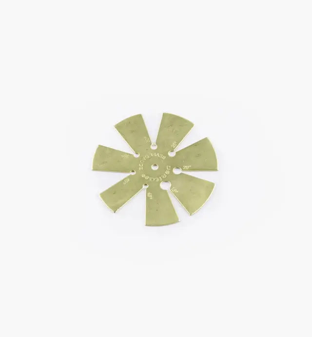 Brass feeler gauge for precise woodworking tool calibration on white background