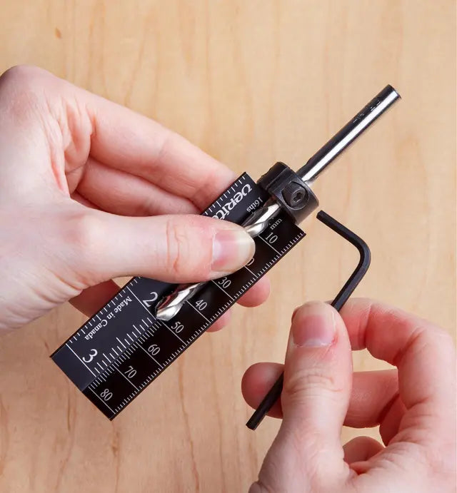 Adjusting drill bit depth stop with hex key and precision measuring jig for woodworking