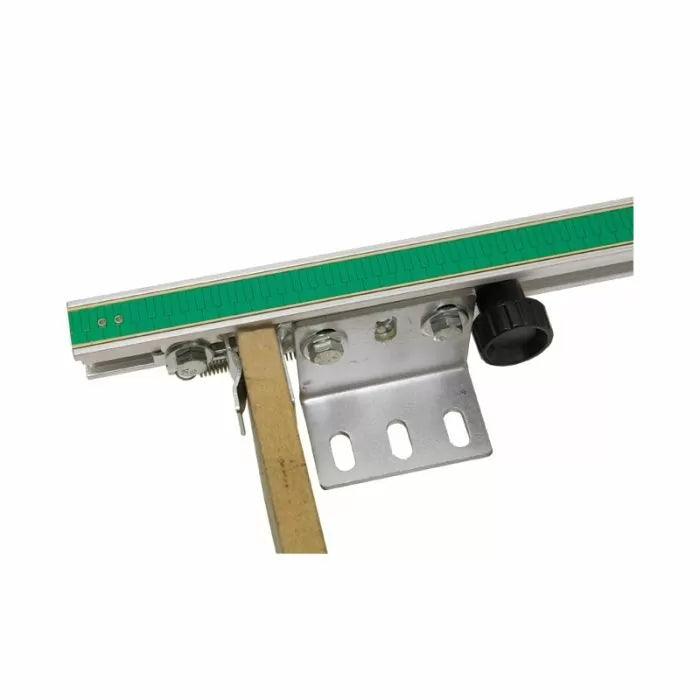 Close-up of a woodworking router table fence with green ruler and adjustable knob
