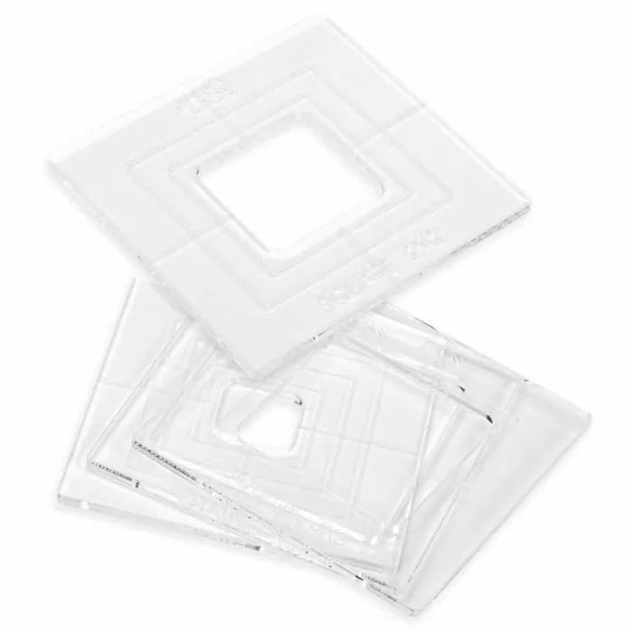 Clear square router table insert rings for woodworking, stacked on white background