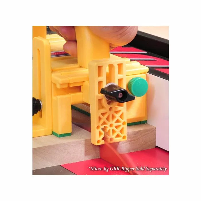 Yellow woodworking push block jig guiding wood on a table saw for safe, precise cuts